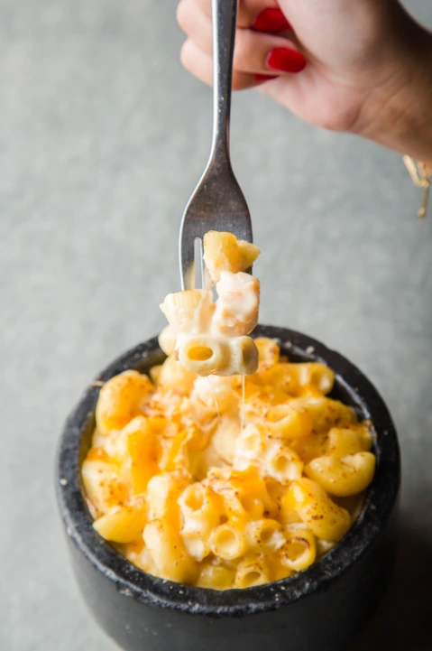 A bowl of mac and cheese with three types of melted cheeses.