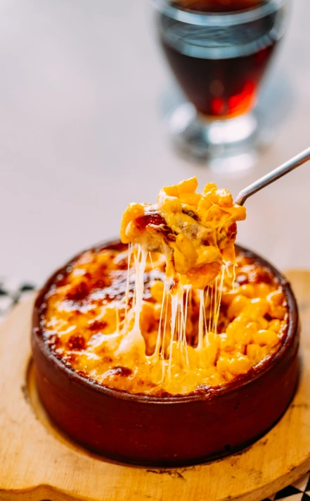 A bowl of mac and cheese with three types of melted cheeses.